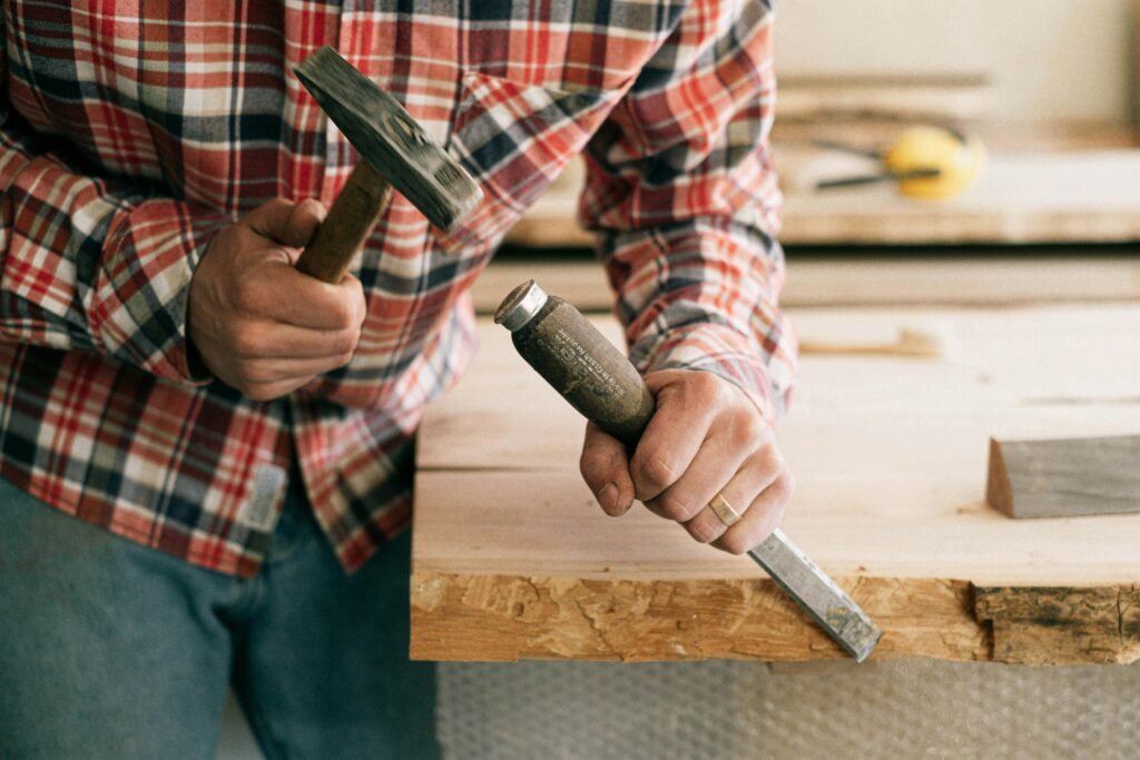 A skilled artisan working on a piece of custom wooden furniture in a workshop, showcasing the craftsmanship involved.