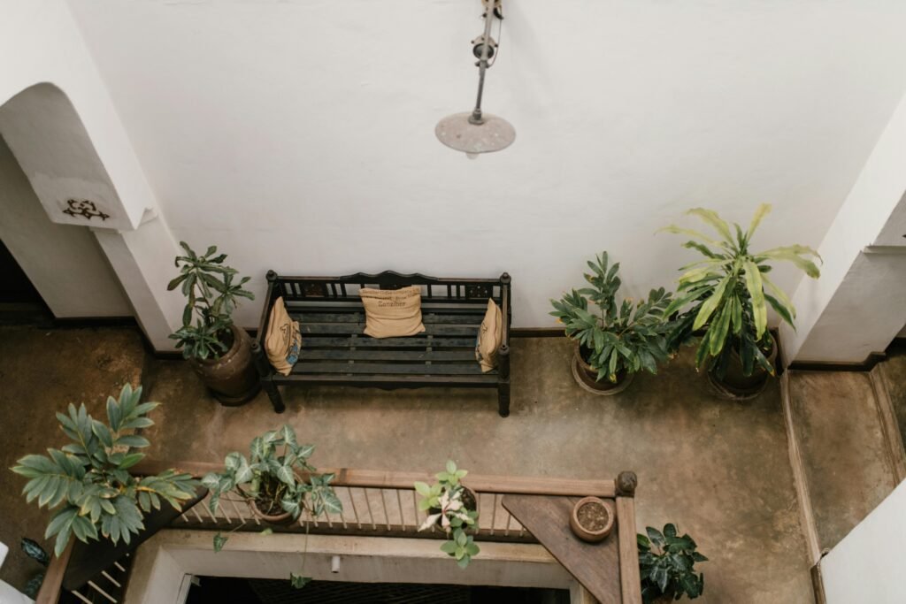 A small, beautifully decorated balcony featuring cozy seating, lush plants in various planters, and string lights, showcasing inspiring balcony decoration ideas. o Caption: Transform your small balcony into a stunning outdoor oasis with creative balcony decoration ideas.